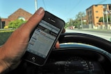 A driver uses a mobile phone while driving