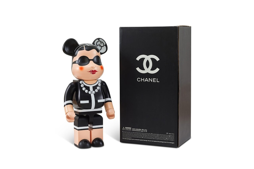 A Bearbrick intended to look like Coco Chanel and a Coco Chanel branded black box. 