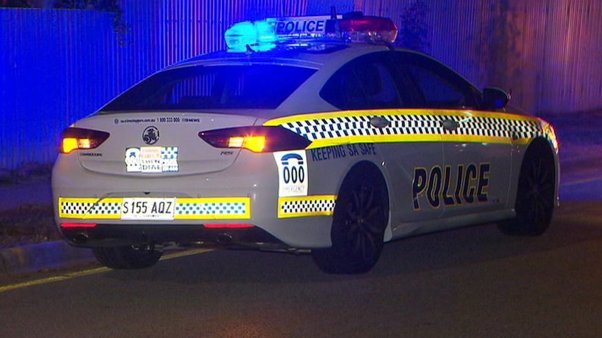 A police car at night with blue lights flashing