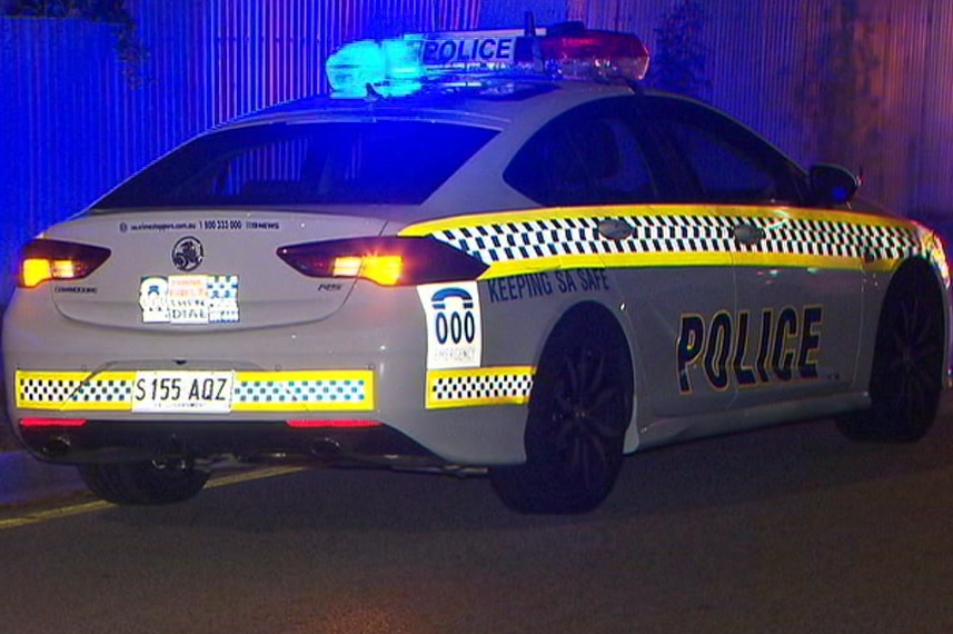 A police car at night with blue lights flashing