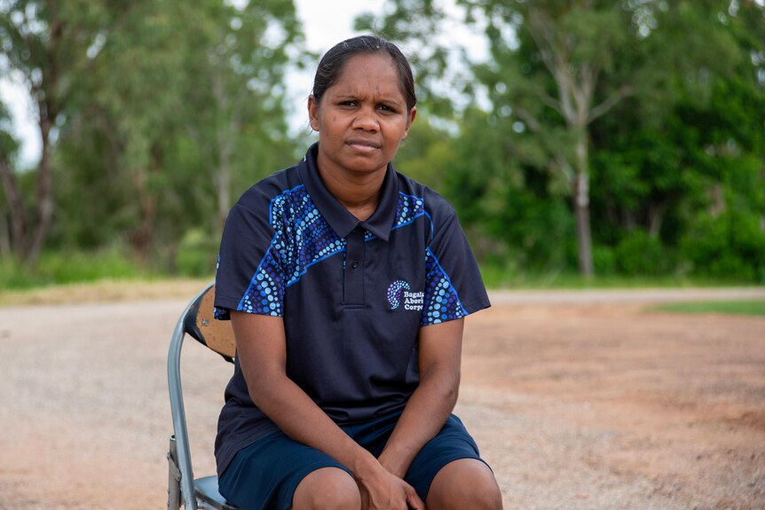 A young woman sits on a chair in the remote community of Barunga. 