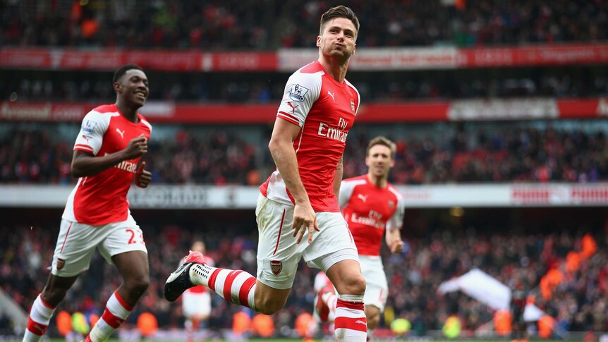 Olivier Giroud celebrates with Danny Welbeck after scoring Arsenal's fourth against Liverpool.
