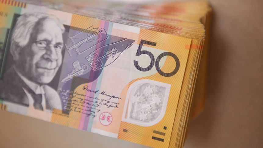 Stack of several thousand dollars worth of Australian $50 notes.