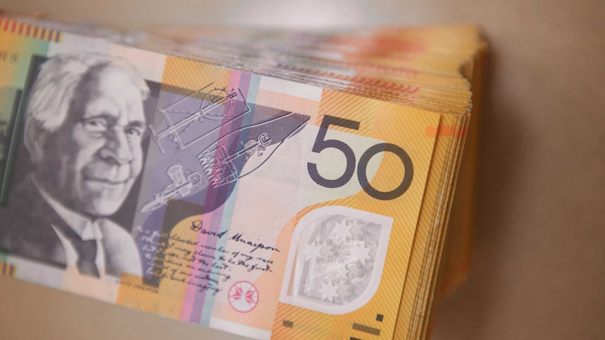 Stack of several thousand dollars worth of Australian $50 notes showing David Unaipon