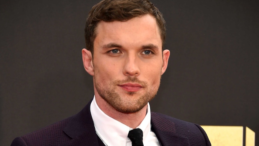 Ed Skrein purses his lips at a red carpet premiere for deadpool