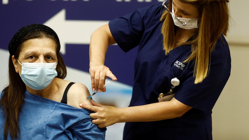 A woman receives a fourth dose of the COVID-19 vaccine 