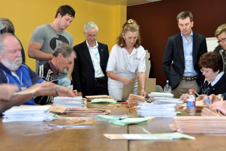 Australian Electoral Commission officials count votes from the federal election in the seat of Hasluck, Perth