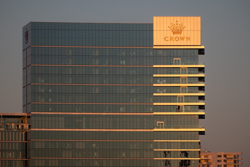 Tall buildings on the banks of a river in the dusk light.