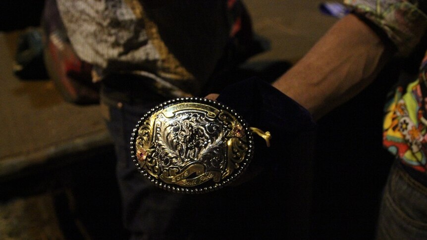 a man holding a belt buckle