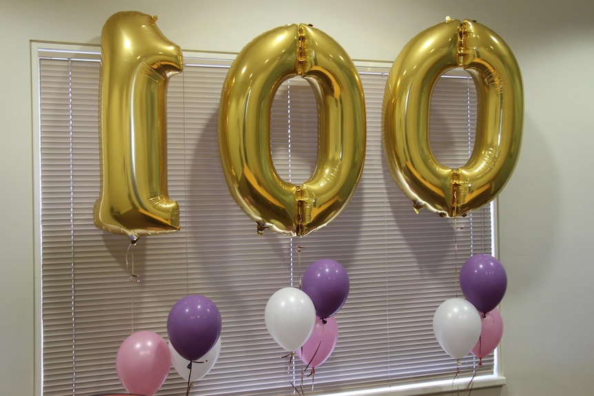 Gold balloons spelling out 100