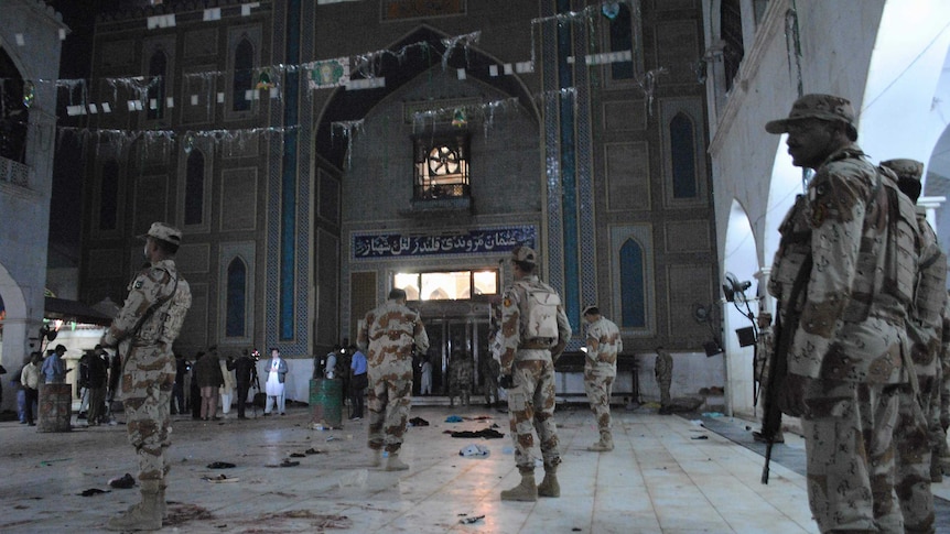 Pakistani para-military soldiers stand alert after a deadly suicide attack.