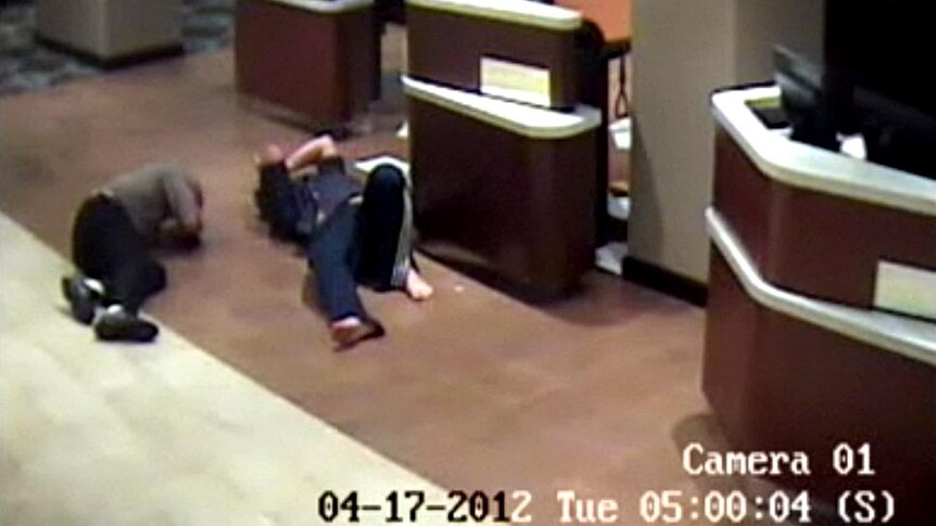 CCTV still of Matthew Newton on floor of Miami hotel foyer.