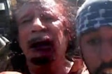 Moamar Gaddafi moments after his capture