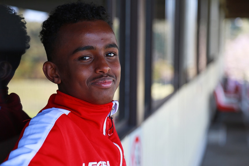 Portrait of a young teenager in his soccer uniform.