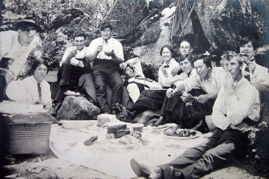 Rostrevor Hop Garden workers sitting around, drinking tea and having a picnic.