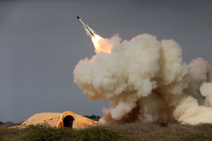 A long-range S-200 missile is fired in a military drill in the port city of Bushehr, Iran. There is a huge cloud of smoke.