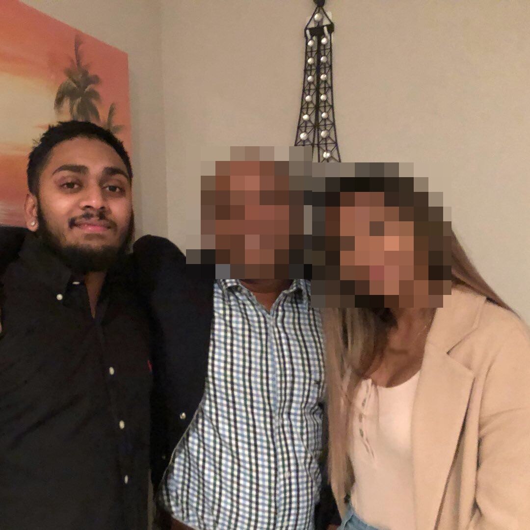 Vin Chinnien with a piercing in his ear, wearing a black button shirt