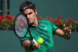 Roger Federer hits a forehand to Stan Wawrinka during the men's final at the Indian Wells Masters on March 19, 2017.