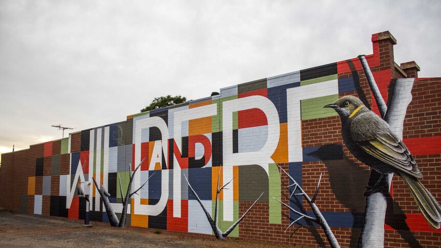 Image of a mural on the wall of a real estate agent in Kalgoorlie.