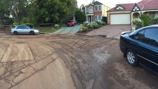 Muddy residue on an Adelaide cul-de-sac after a burst water main