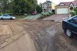 Muddy residue on an Adelaide cul-de-sac after a burst water main