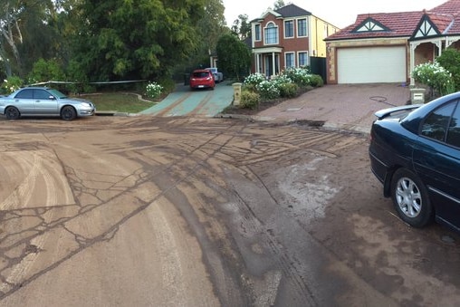 Muddy residue on an Adelaide cul-de-sac after a burst water main