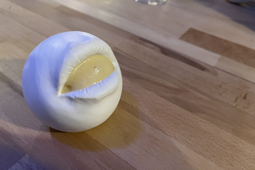 Citrus foam served in a plaster cast of a man's mouth.