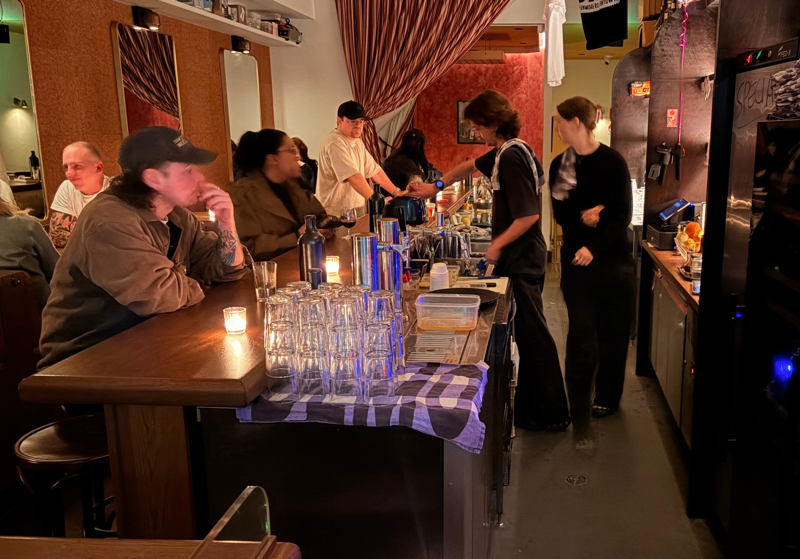 People sat at dimly lit bar