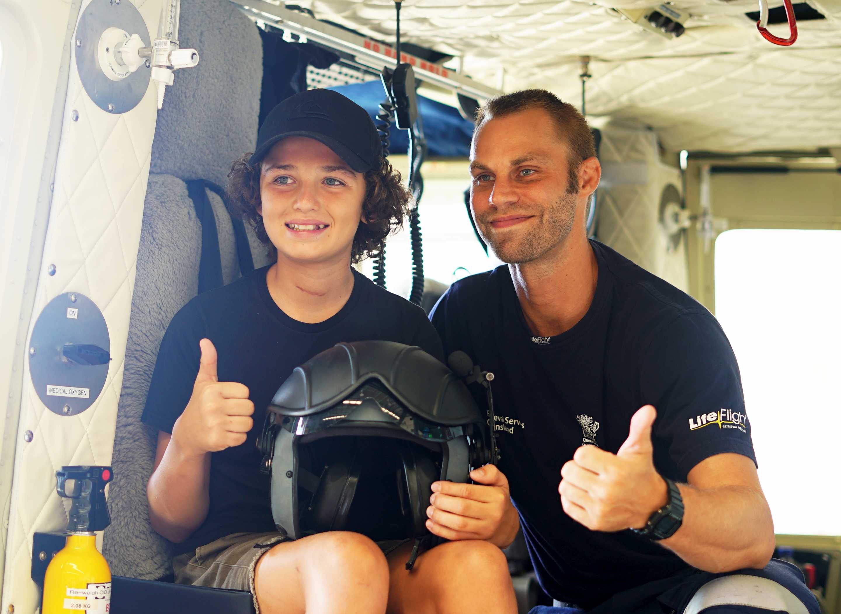 12yo Connor Creagh in a LifeFlight Rescue helicopter with one of the crew that aided him after he was crushed by a tree in 2018