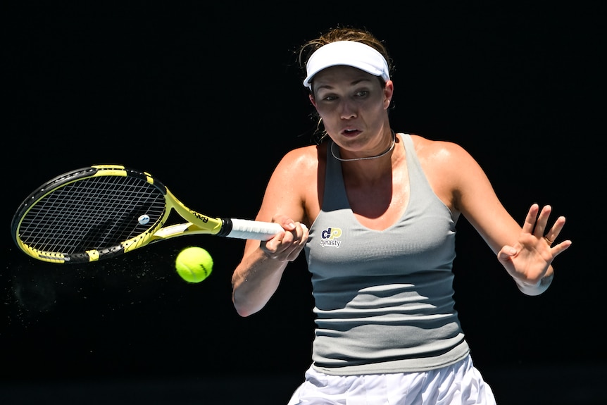 An American female tennis player hits a forehand return at the Australian Open.