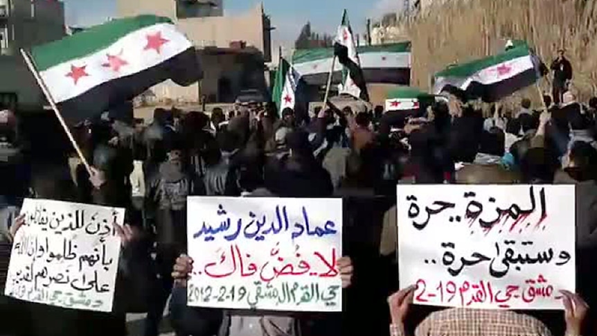 Syrians wave the former pre-Baath flag during an anti-regime protest. (AFP: YouTube)