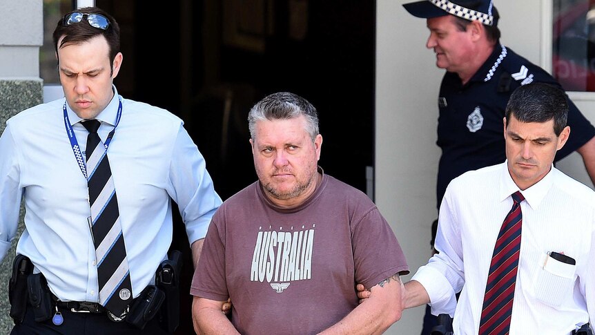 Rick Thorburn escorted by police from a police station