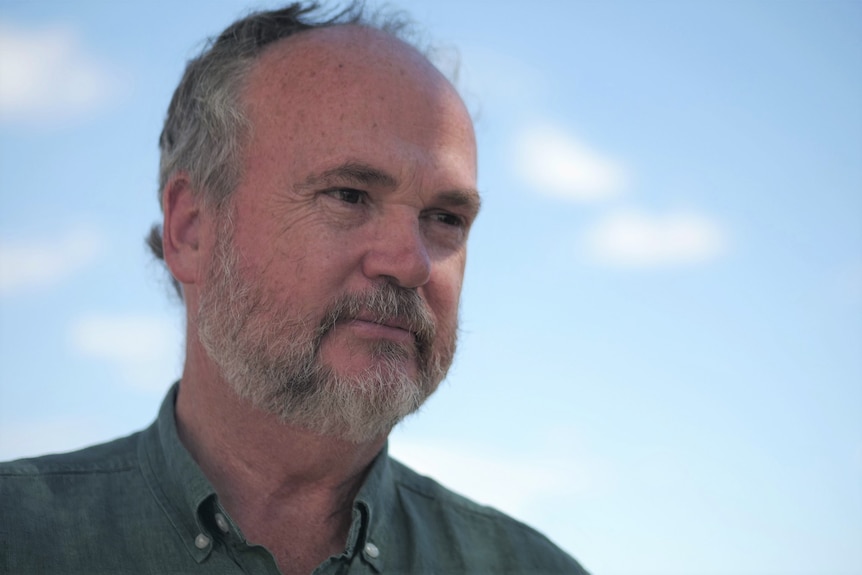 Bearded man wearing green shirt