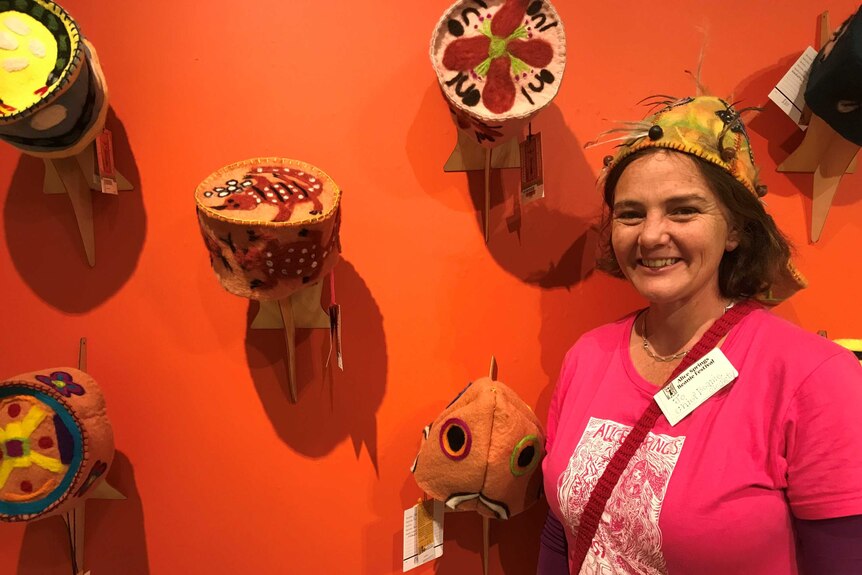Jo Nixon standing in front of a wall of felt beanies