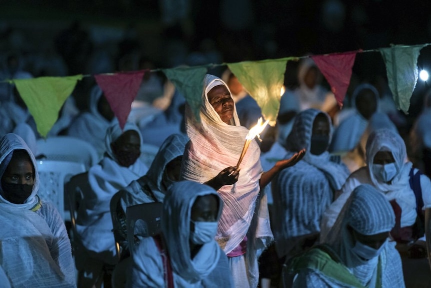 Ethiopian Orthodox Christians light candles and pray for an end to the war.
