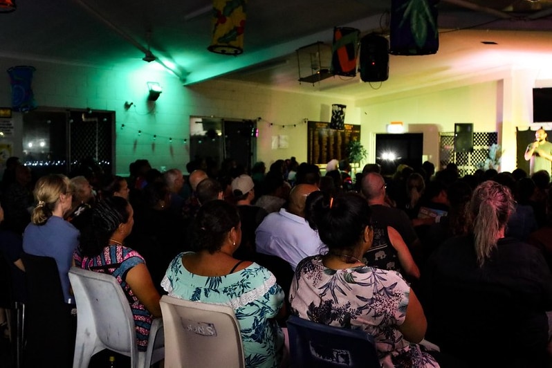 In the far right, Indigenous comedian Leon Filewood performs in front of large crowd, many of whom were family and friends.