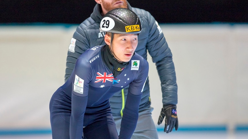 Andy Jung skates on the ice with his hands on his knees.