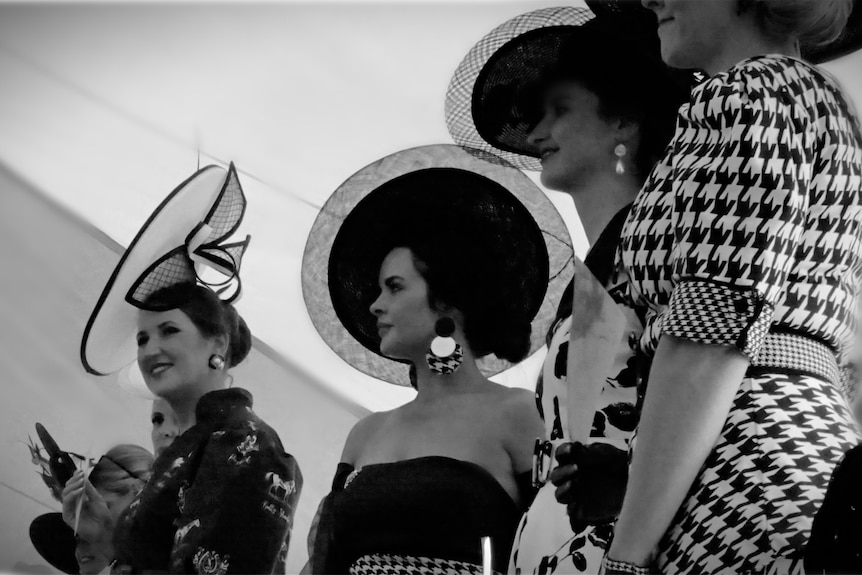 Lady wearing circular black hat Cloncurry Races