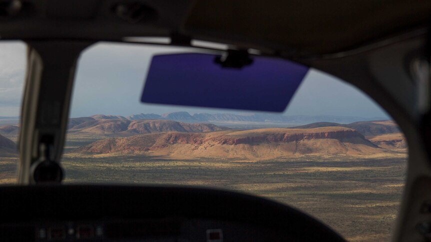 The view of the Rawlinson Ranges from a cockpit flying into Warakurna.