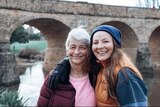 Naomi Hutchings with her mum Dianne stand in front of a bridge
