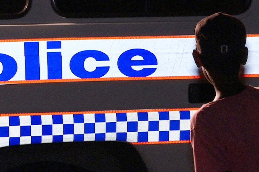 A twelve year-old child answers responds to questions about his evening, before being driven home by police in Mount Isa.
