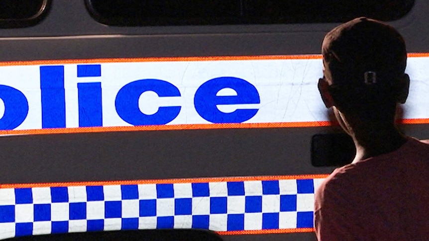 A twelve year-old child answers responds to questions about his evening, before being driven home by police in Mount Isa.
