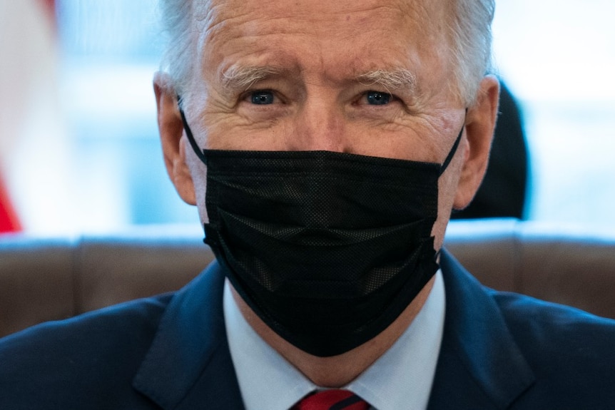President Joe Biden delivers remarks on health care while wearing a mask