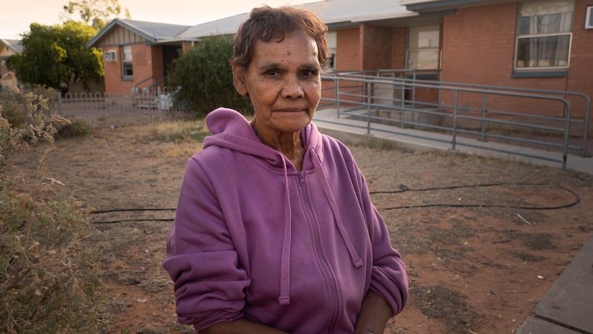 A woman wearing a purple hoodie.