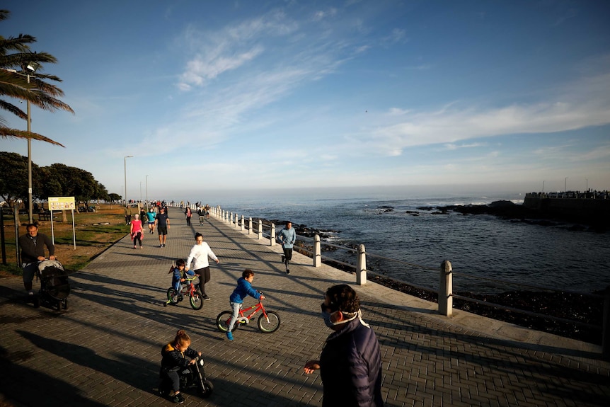 A board walk in South Africa with runners, joggers and cyclists