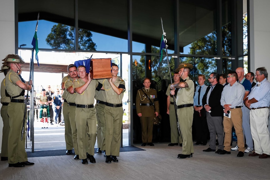 Stuart Reddan's coffin carried into his funeral service at Buderim