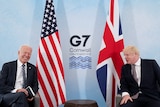U.S. President Joe Biden laughs while speaking with Britain's Prime Minister at G7 summit.