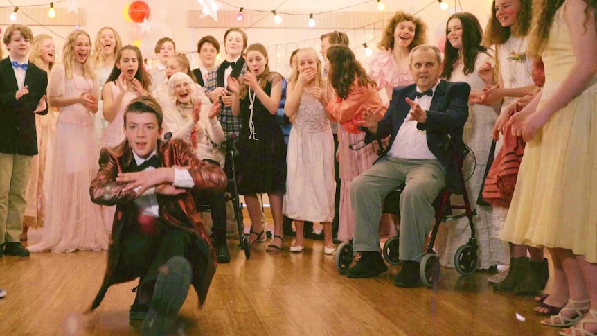 High school students and aged care residents do a dance for a lip sync video