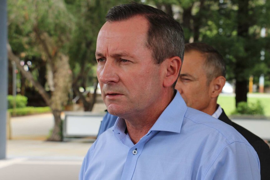 A head and shoulders shot of WA Premier Mark McGowan speaking outdoors wearing a blue collared shirt.