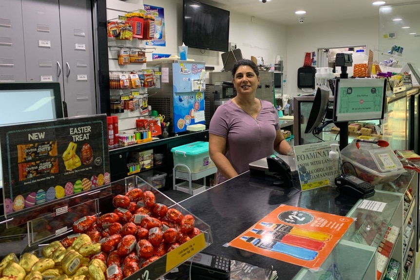 Kerry stands behind the counter of her store.